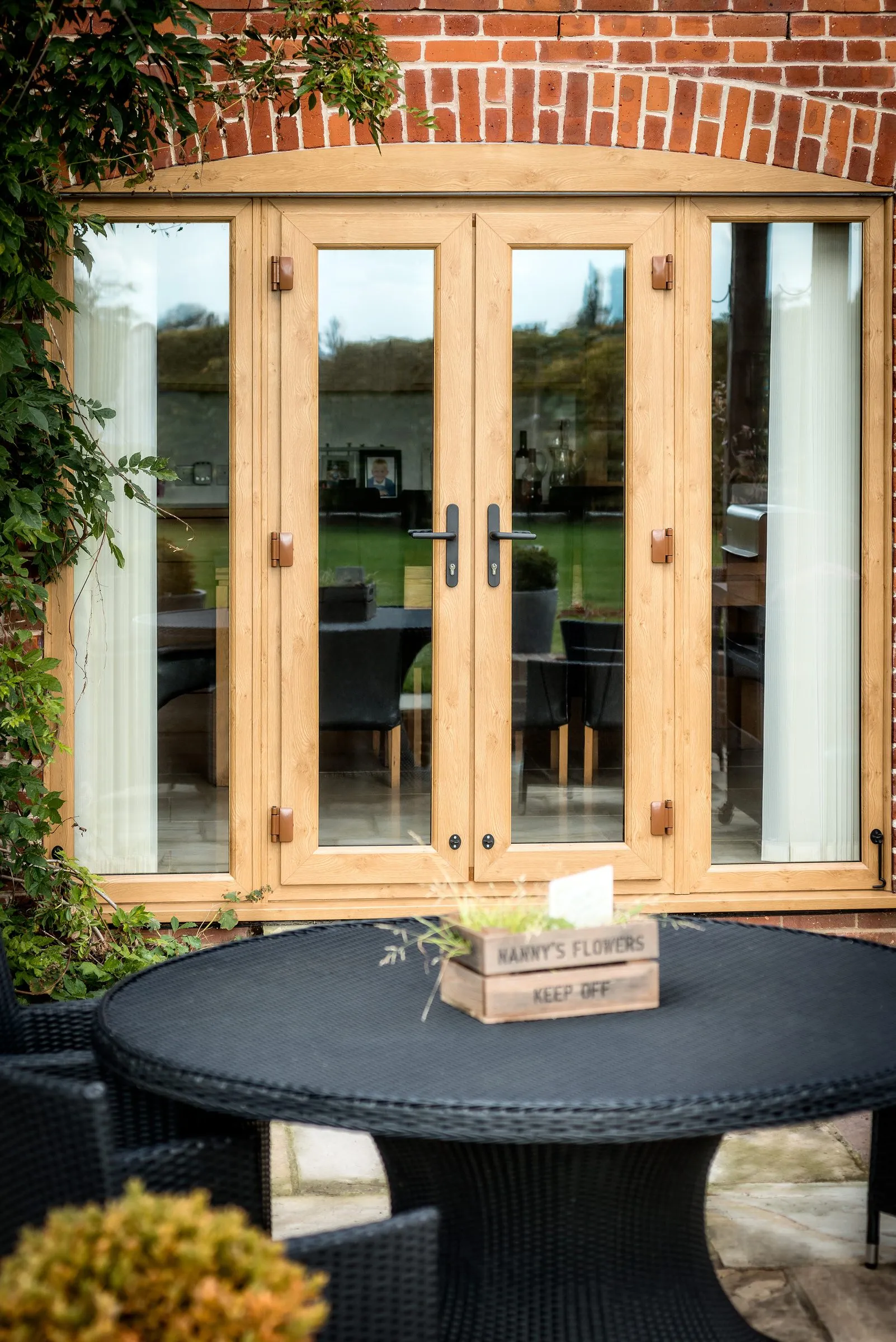 Liniar French doors in Irish Oak opening onto a patio