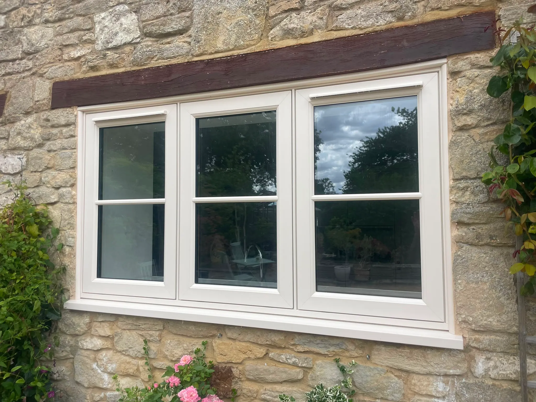 Cream uPVC windows set in a stone wall