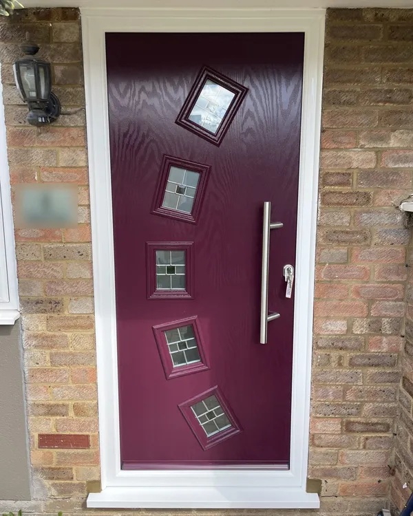 Contemporary purple composite front door with five small tilted square glass panels and a long stainless steel bar handle, in a white frame.