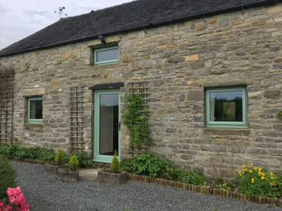 Green UPVC Windows and Door fitted in a stone cottage