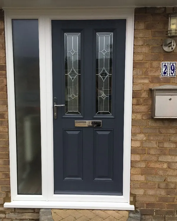Grey composite front door with decorative glass panels and frosted side panel