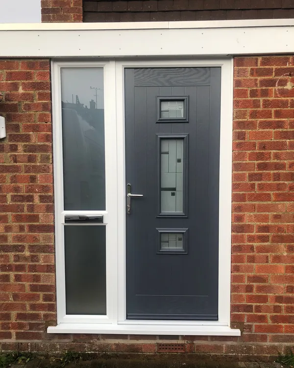 Grey composite door with three square decorative glass panels and side windows