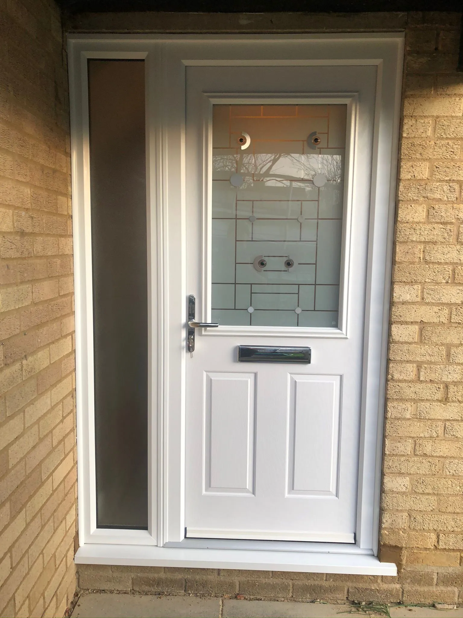 White composite front door with patterned glass and side panel