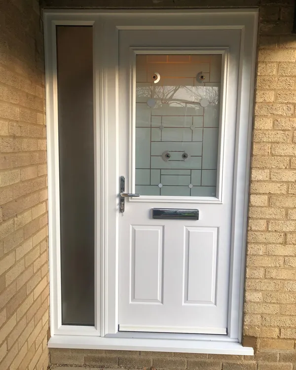 White composite front door with patterned glass and side panel