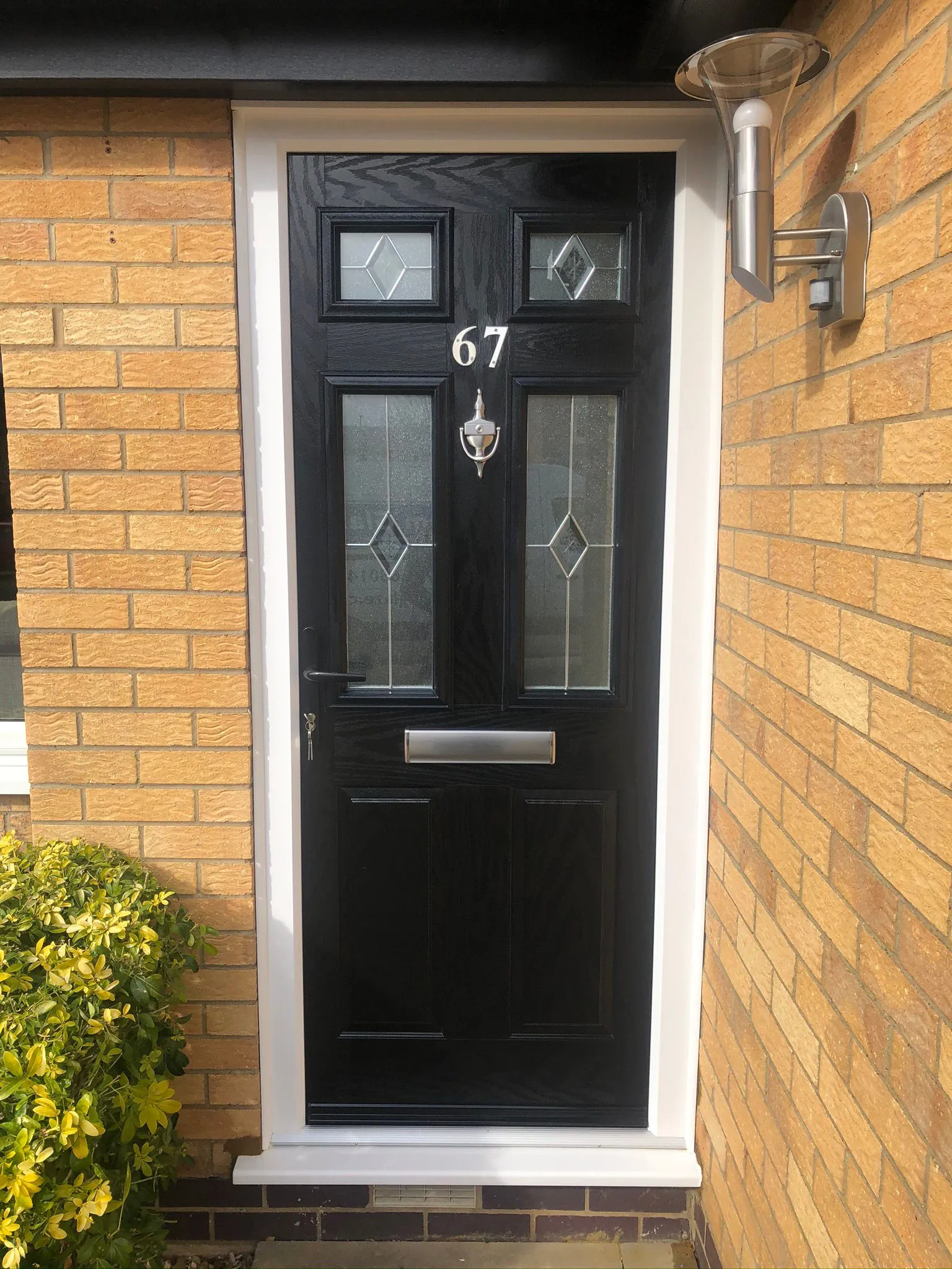 Black composite front door with diamond decorative glass and chrome knocker