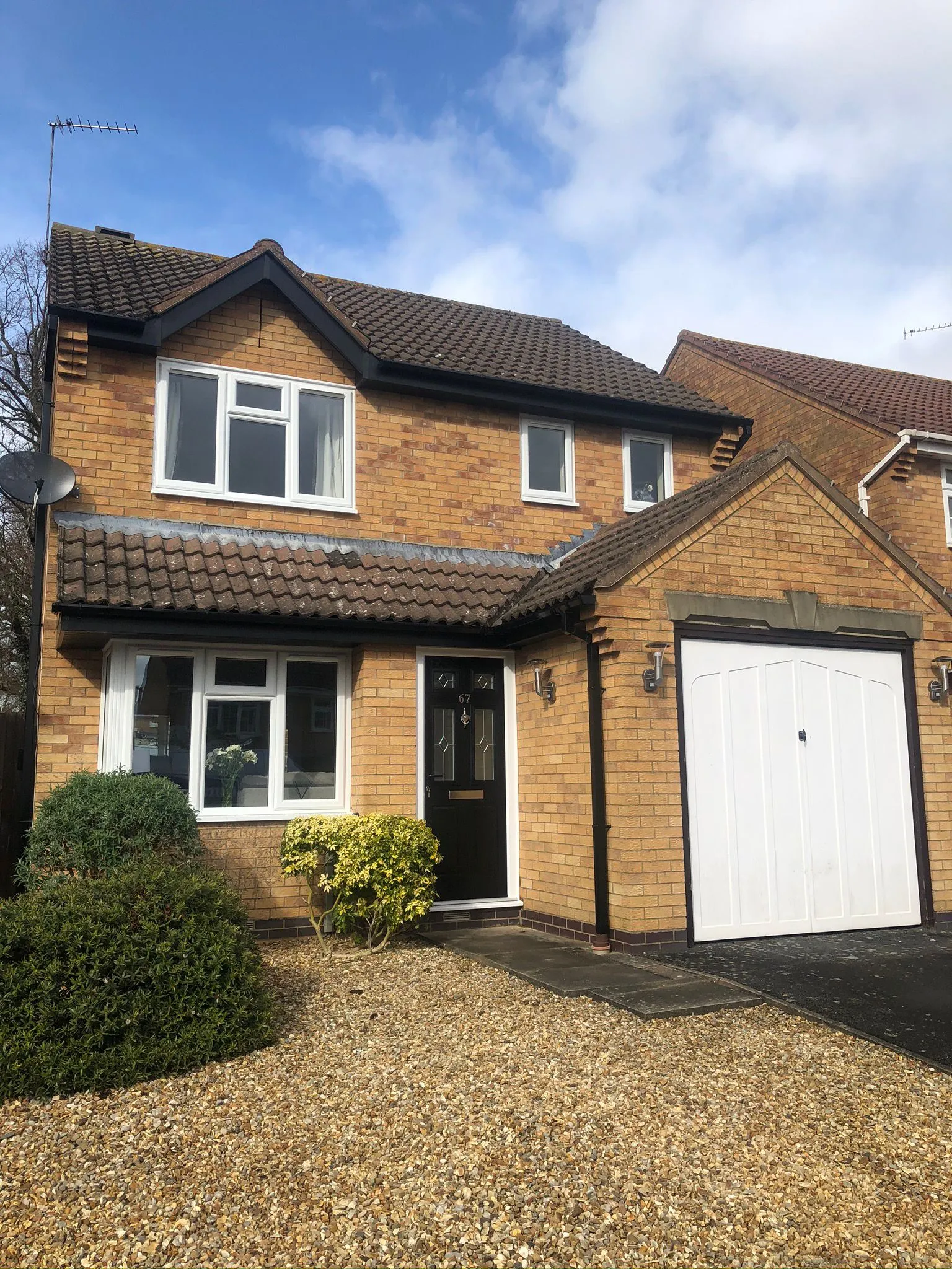 House with new UPVC windows and black composite front door