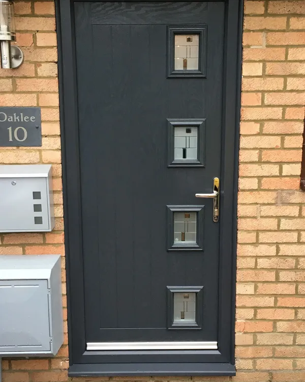 Modern grey composite front door with four decorative glazed panels