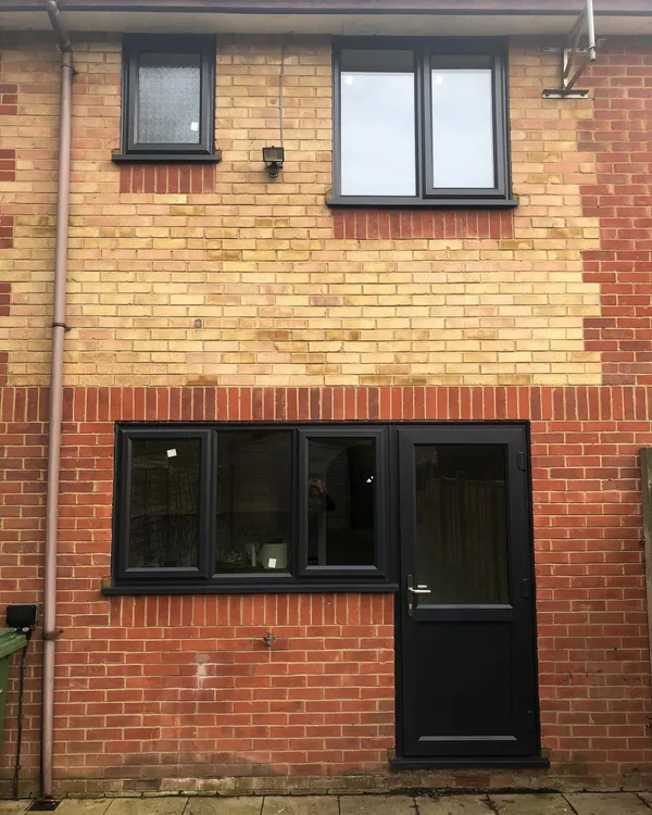 Grey UPVC windows and rear back door on brick property