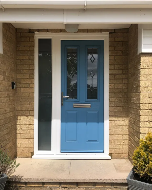 Blue composite front door with decorative glass and frosted side panel