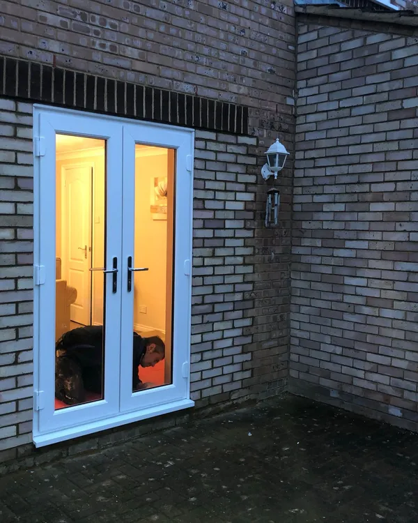 White UPVC French doors opening to garden area