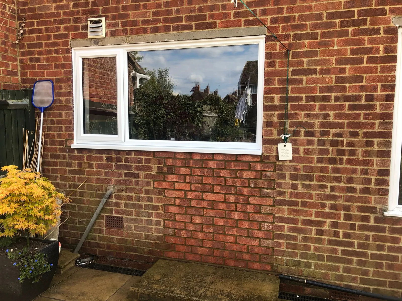 White UPVC casement window installed on a brick wall