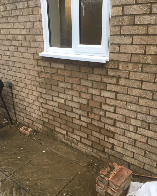 White UPVC window installation on a brick home