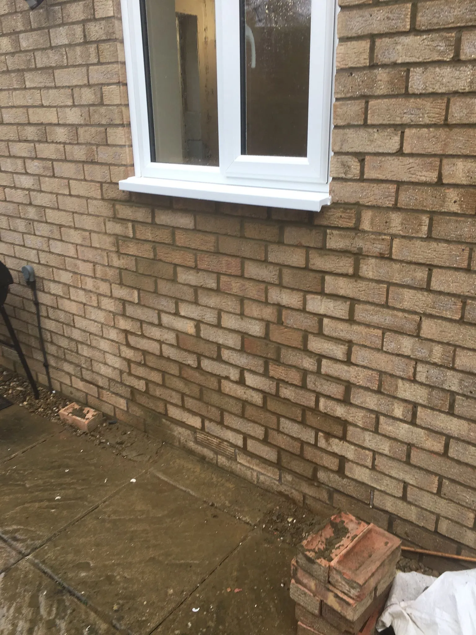 White UPVC window installation on a brick home