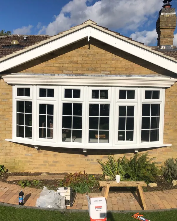 White UPVC bow bay window with grid design on a bungalow