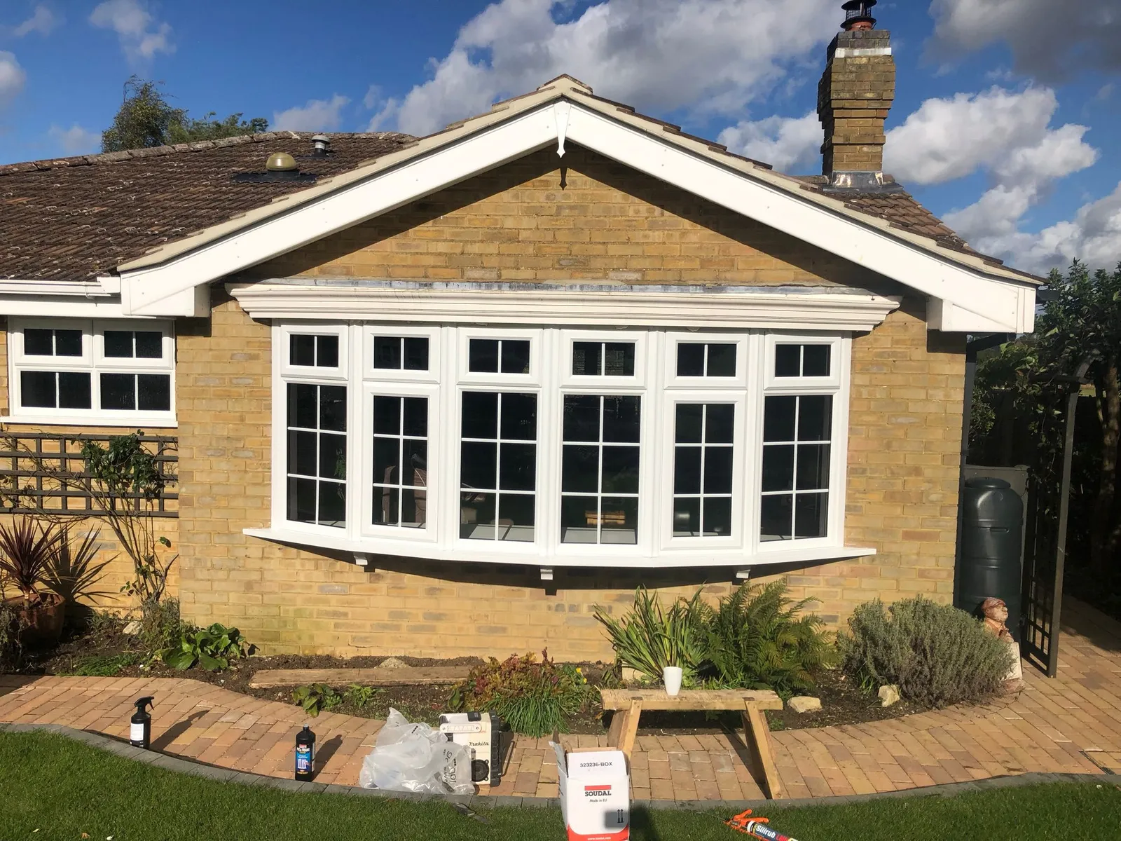 White UPVC bow bay window with grid design on a bungalow