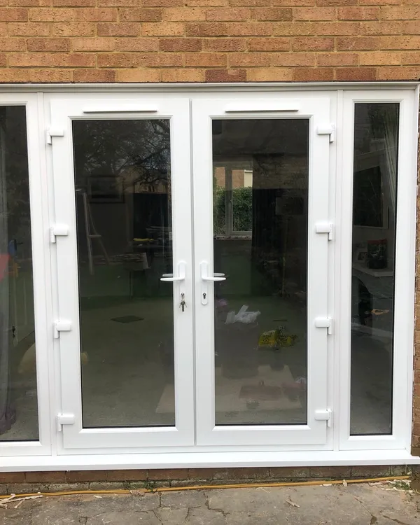 White UPVC French doors with narrow glazed side panels
