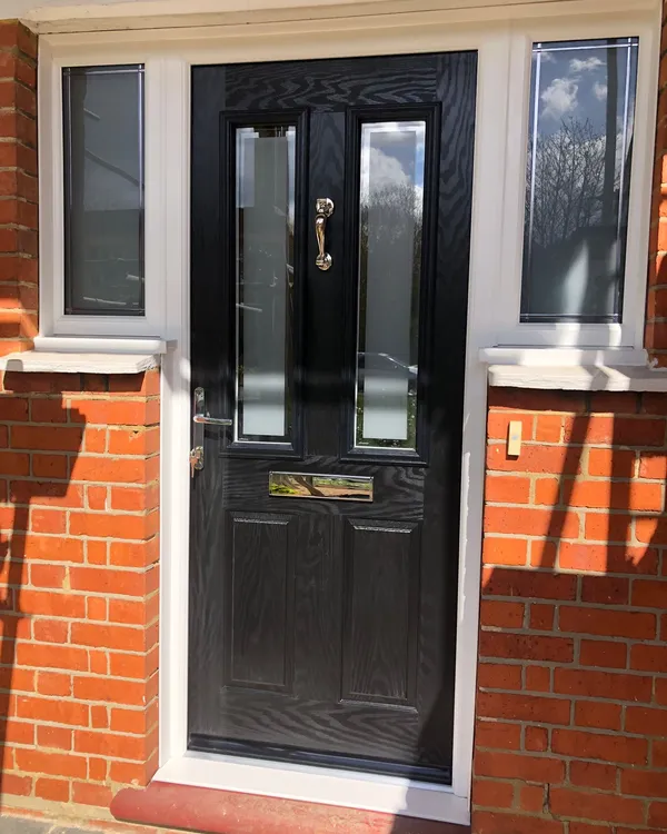 Black composite front door with two vertical glazed panels and chrome furniture