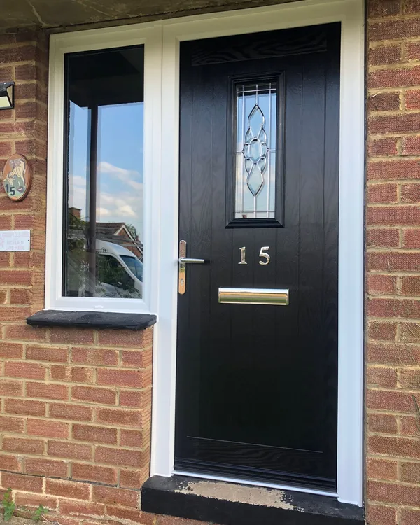 Black composite front door with decorative centre glass and left side window