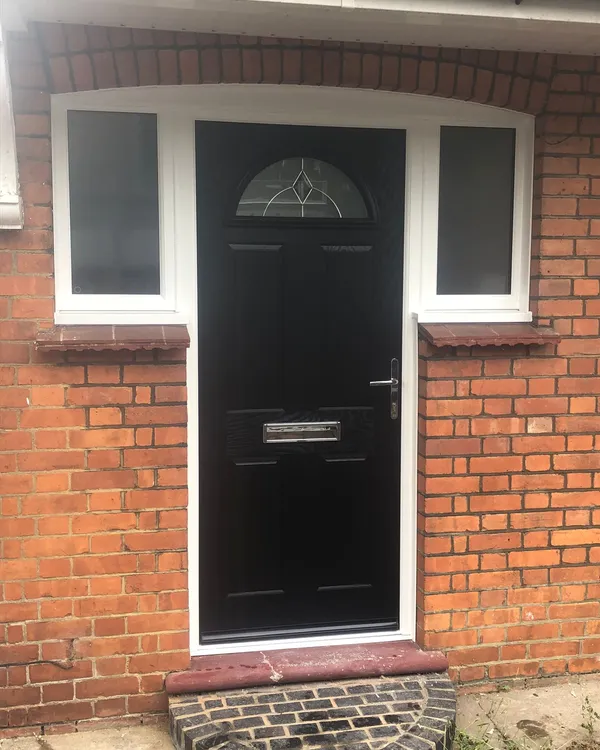 Black composite door with arched glass and frosted side windows