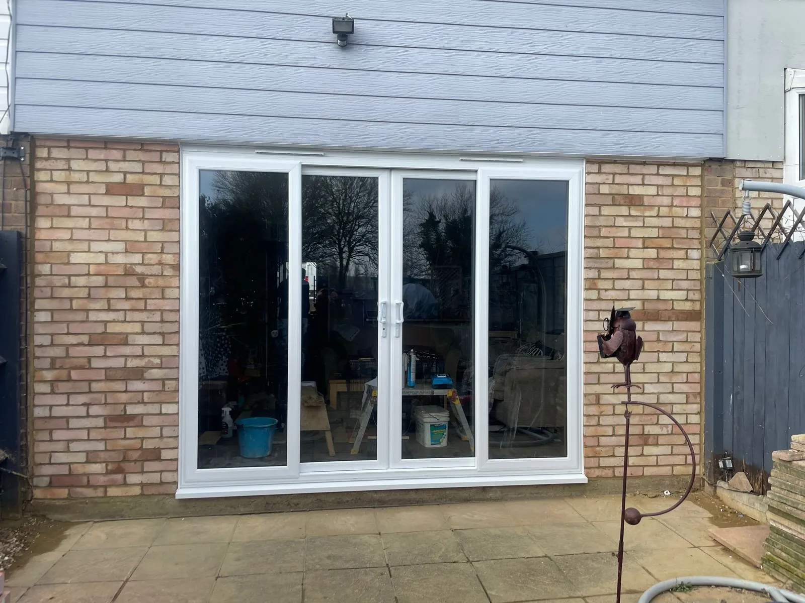 Wide uPVC sliding patio doors in white with glass panels opening to garden patio.