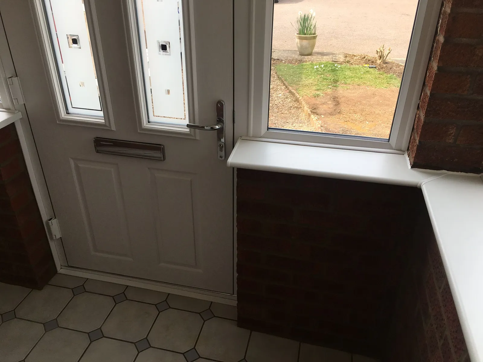White UPVC front door with glazed side window