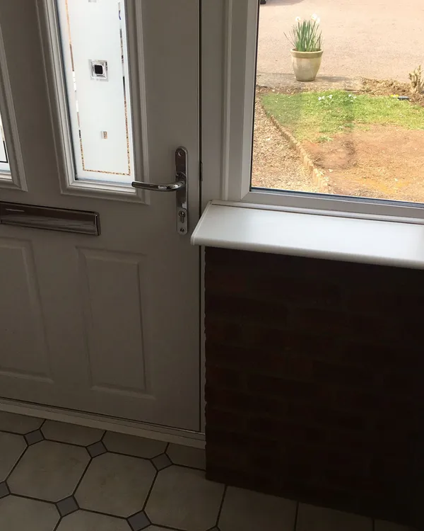 White UPVC front door with glazed side window