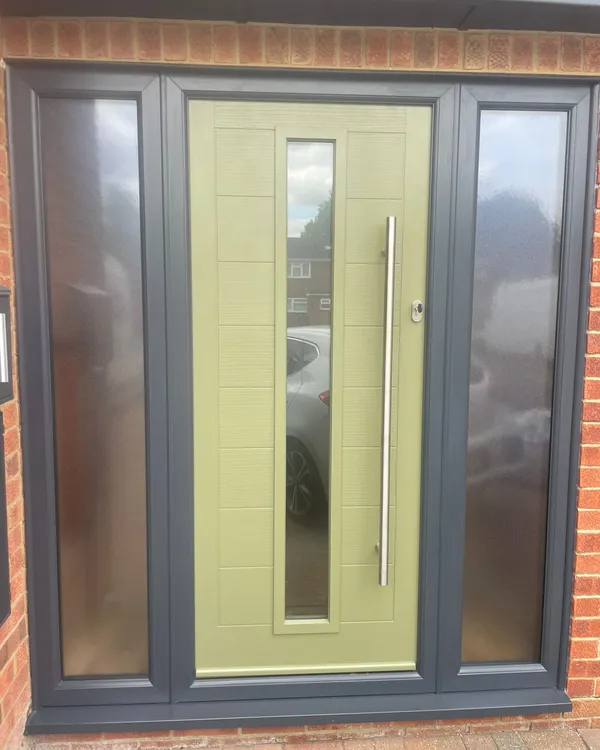Olive green composite front door with tall chrome handle and frosted side panels.