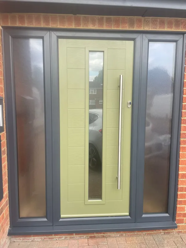 Modern olive green composite front door with side glass panels and chrome handle.