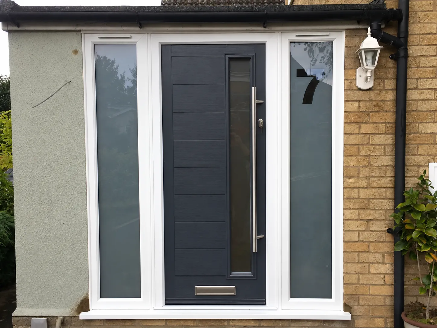 Contemporary grey composite front door with full height glass side panels