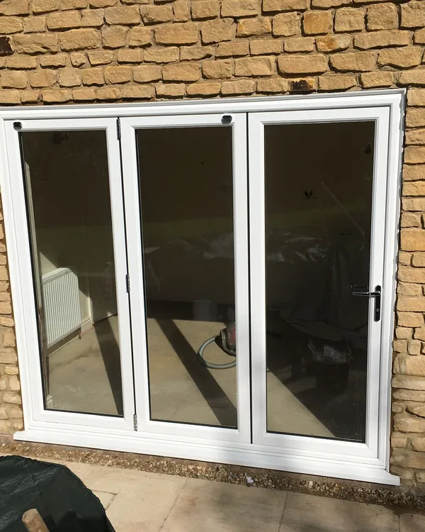 White UPVC French patio doors installed in a stone wall property