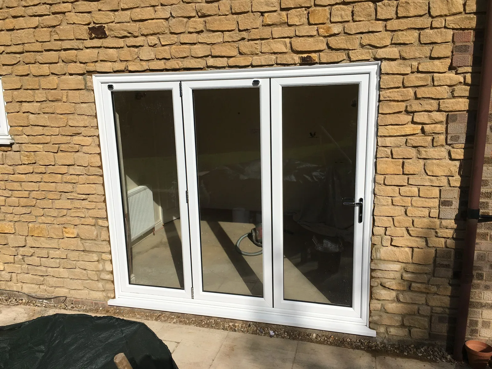 White UPVC French patio doors installed in a stone wall property