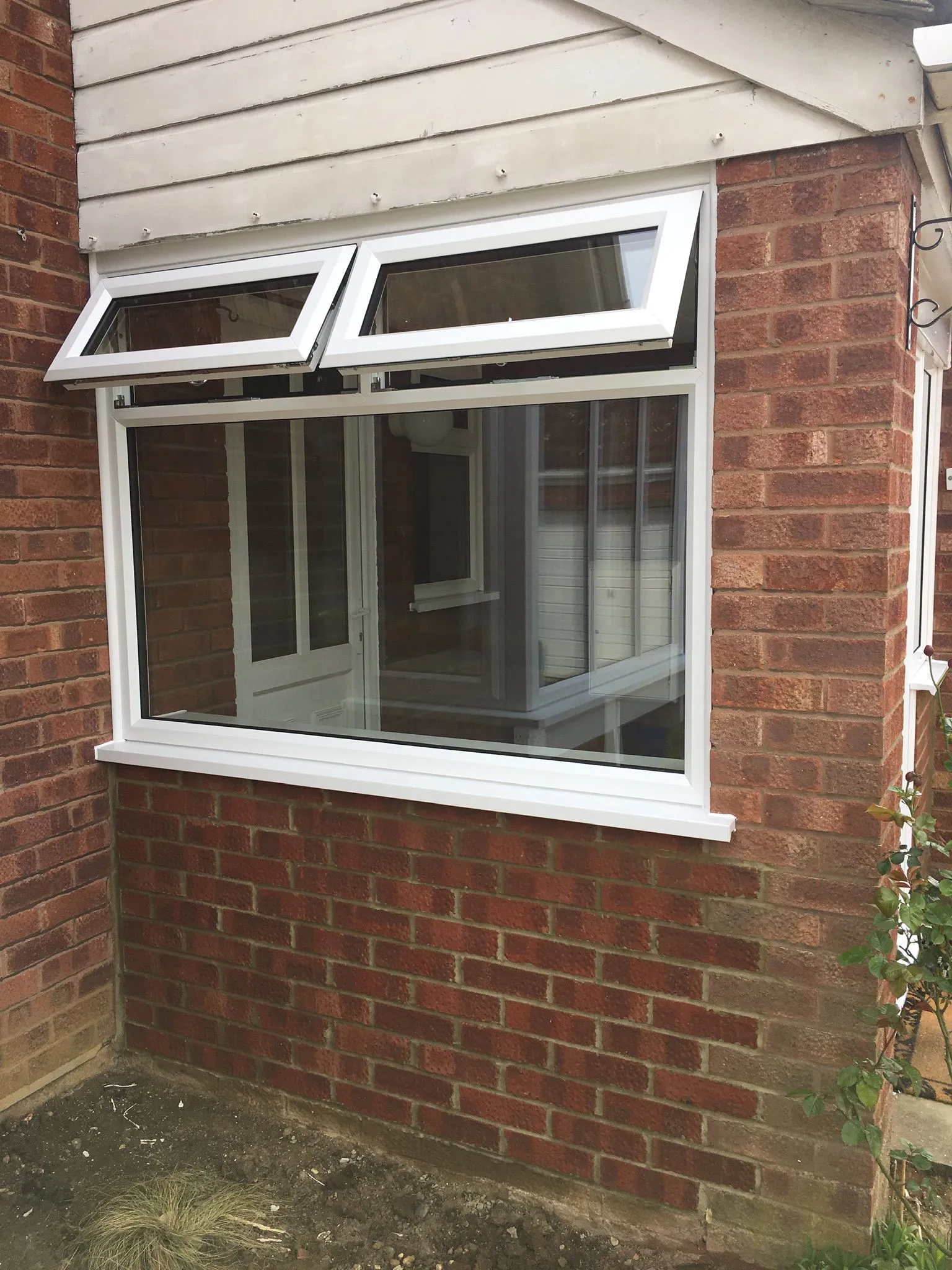 UPVC casement window with top openers on a brick house