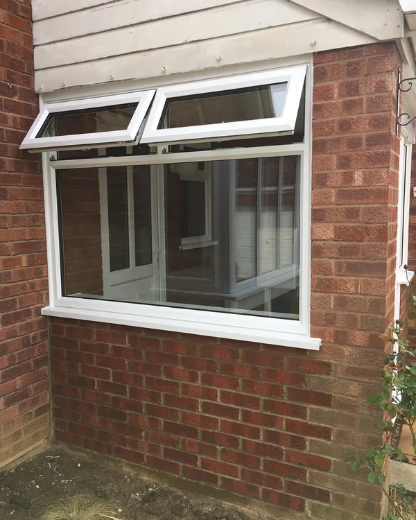 UPVC casement window with top openers on a brick house