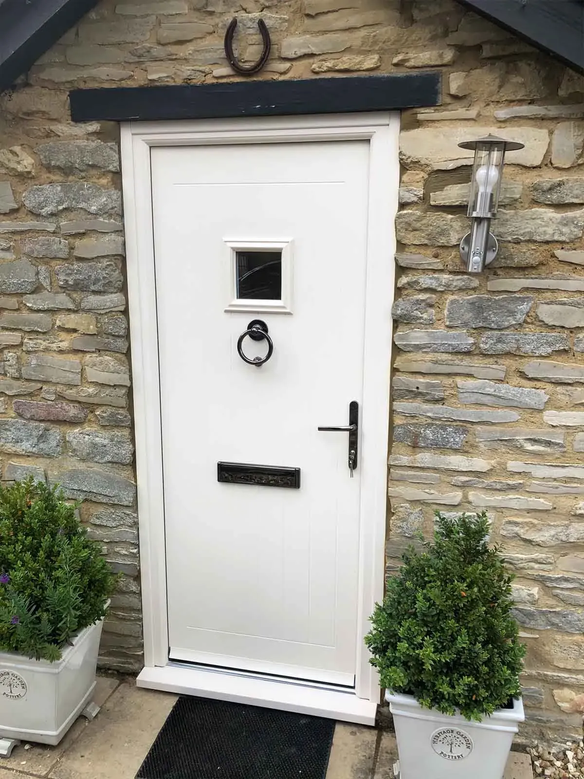 White composite door fitted by Tommy’s Windows on a stone cottage